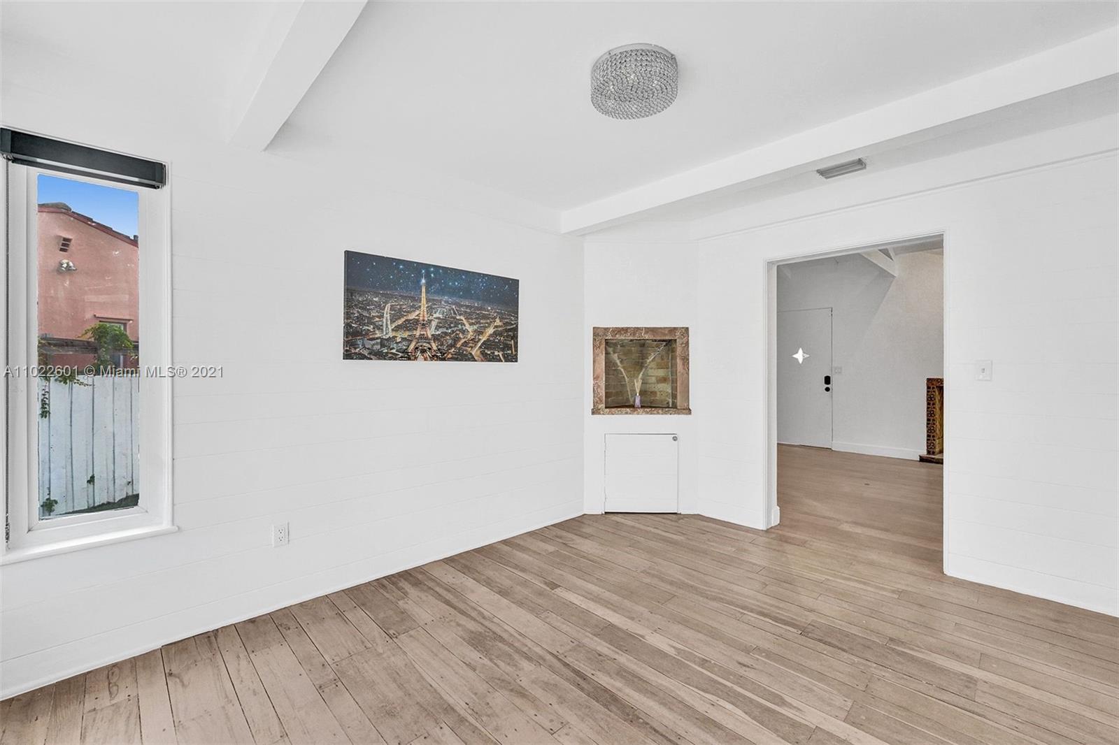 4717 Alton Road Miami Beach, FL 33140 - Photo 8 of 59 a view of empty room with wooden floor