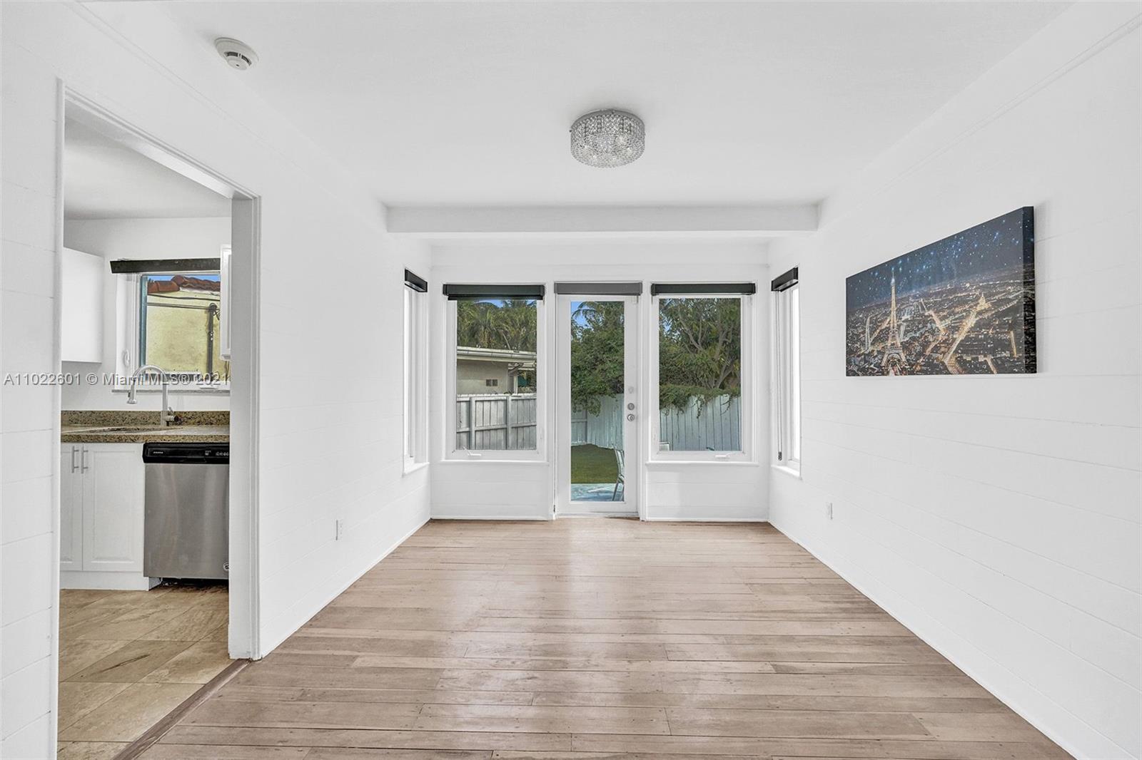 4717 Alton Road Miami Beach, FL 33140 - Photo 9 of 59 a view of a big room with wooden floor and windows