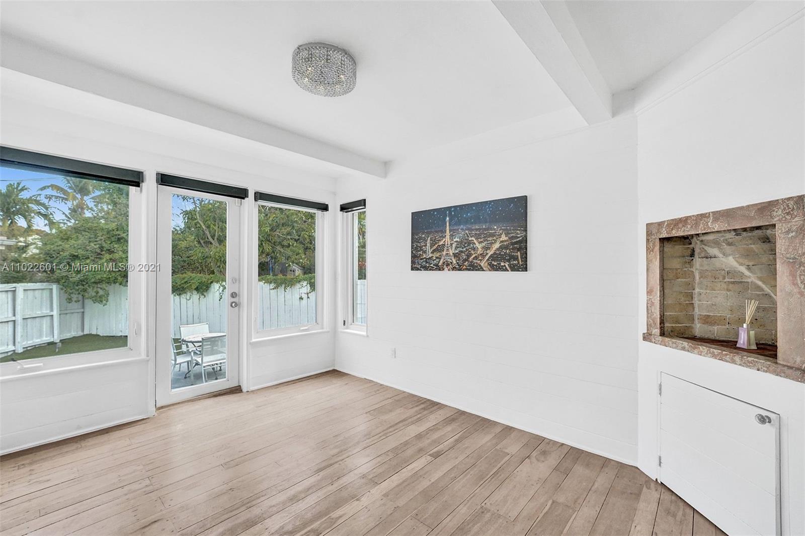 4717 Alton Road Miami Beach, FL 33140 - Photo 10 of 59 a view of an empty room with wooden floor and a window