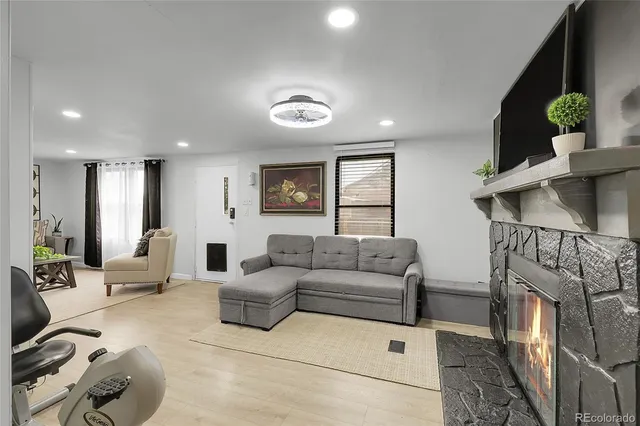 a living room with furniture and a fireplace