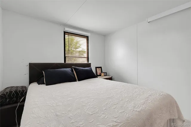 a bedroom with a bed and window