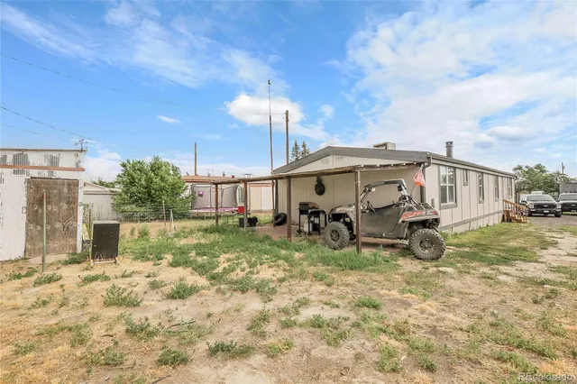 a view of an house with backyard and sitting area
