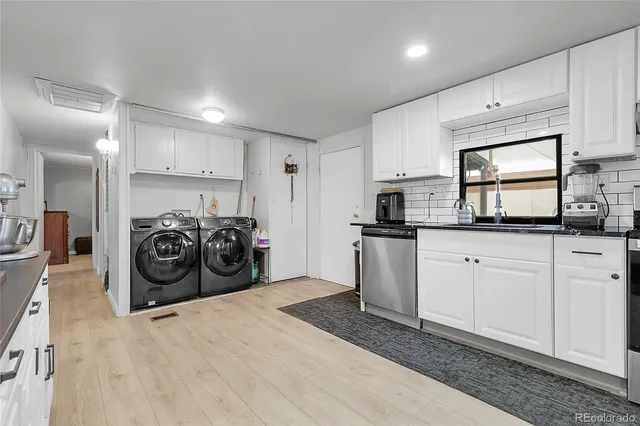 a kitchen with granite countertop a sink and cabinets