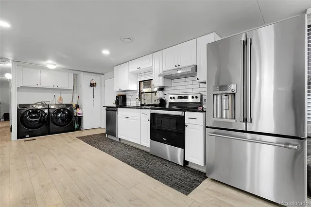 a kitchen with stainless steel appliances granite countertop a refrigerator sink and cabinets