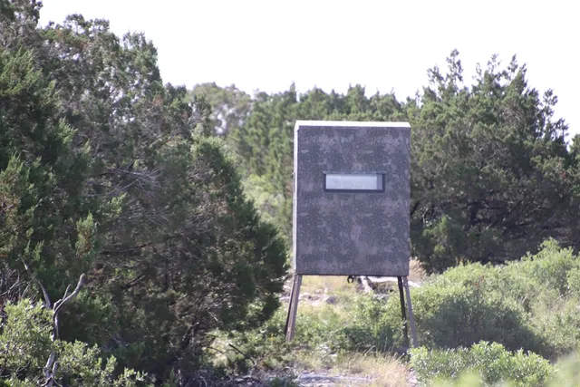 a table and chairs sitting in a backyard of a house