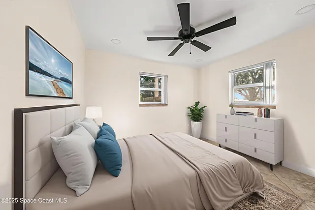 a bedroom with a bed and a painting on the wall