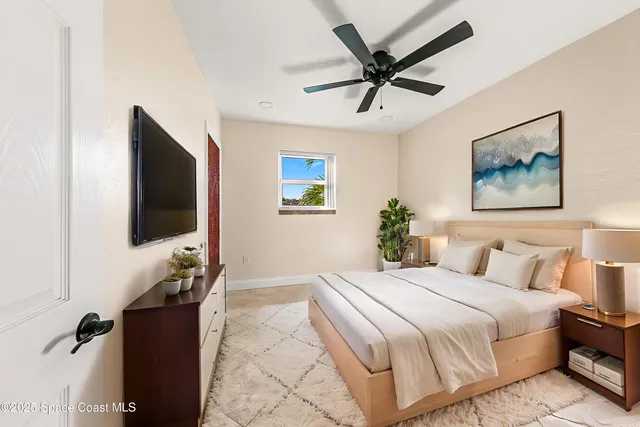 a bedroom with a bed and a flat screen tv