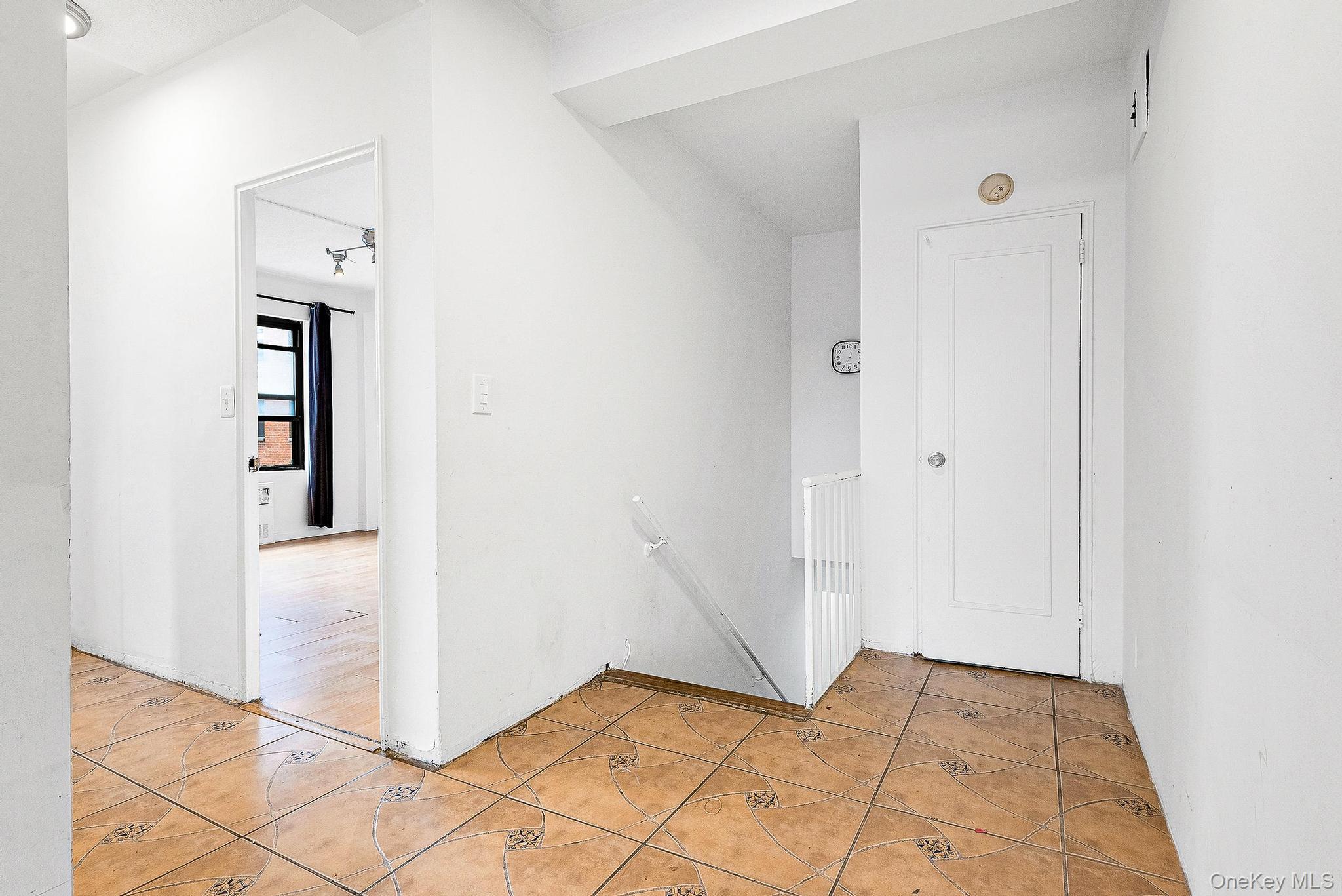 99-32 66th Road, Unit 5B Queens, NY 11374 - Photo 14 of 27 Corridor with an upstairs landing and light tile patterned floors