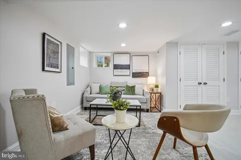 a living room with furniture and a potted plant