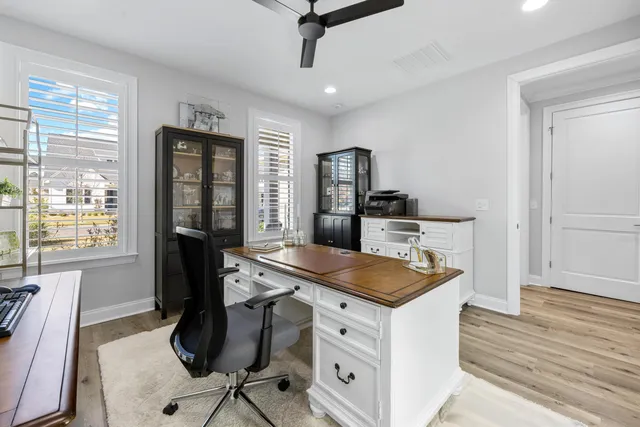 a living room with furniture kitchen view and a refrigerator