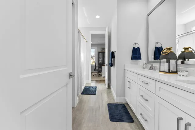 a large kitchen with lots of counter space a sink dining table and a large window