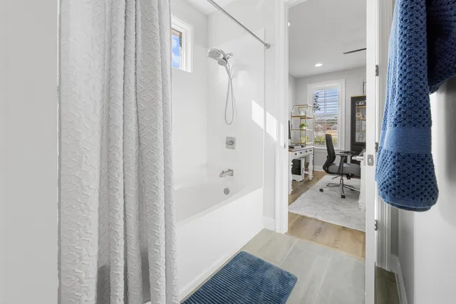 a kitchen with a table chairs and white cabinets