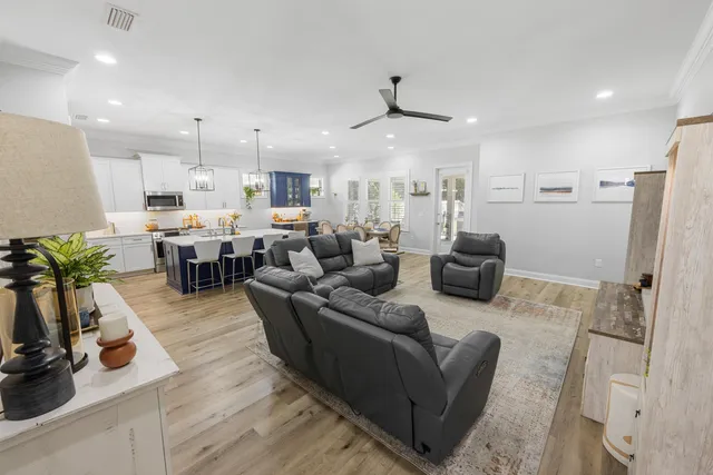 a kitchen with kitchen island granite countertop a sink and wooden floor