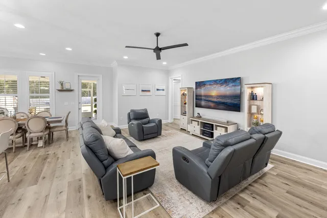 a kitchen with stainless steel appliances granite countertop a sink refrigerator and wooden floor