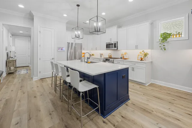 a hallway with a couch and chandelier