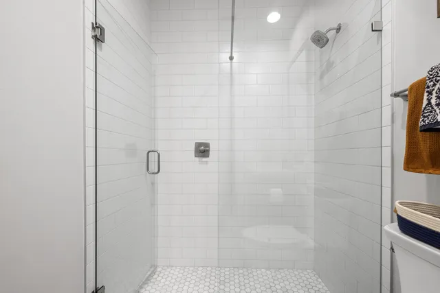 a spacious bedroom with a bed and wooden floor