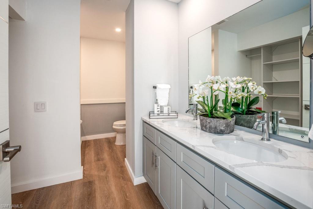 124 Lake Point Lane, Unit 2B Naples, FL 34112 - Photo 18 of 41 a bathroom with a sink a toilet and a mirror