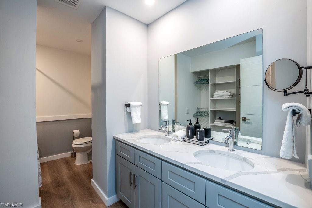 124 Lake Point Lane, Unit 2B Naples, FL 34112 - Photo 21 of 41 a bathroom with a double vanity sink and a mirror