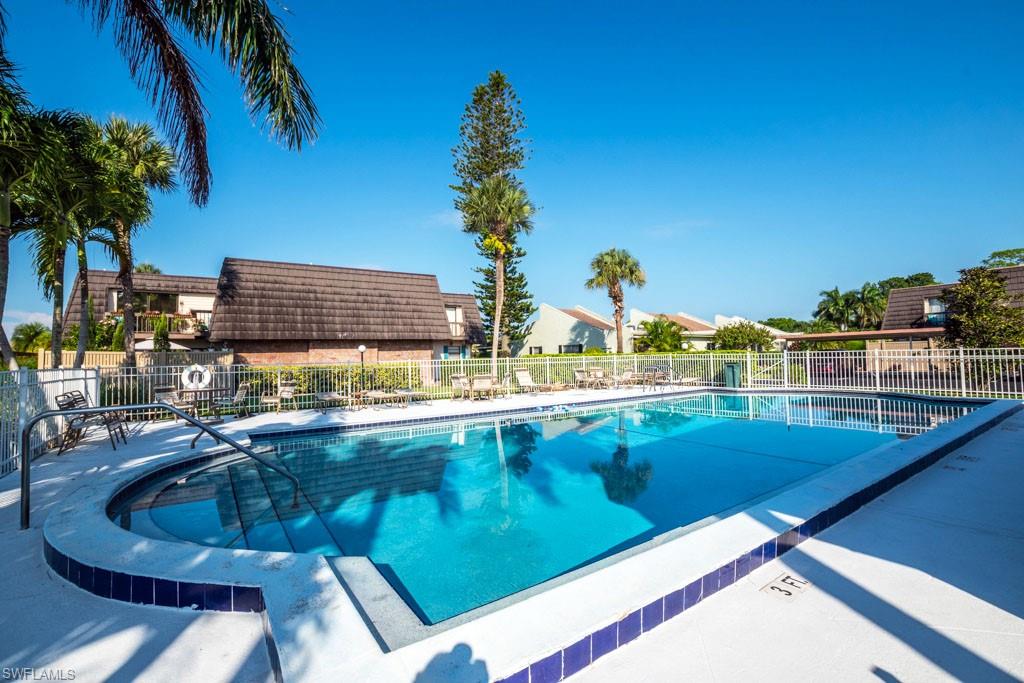 124 Lake Point Lane, Unit 2B Naples, FL 34112 - Photo 40 of 41 a view of a swimming pool with outdoor seating