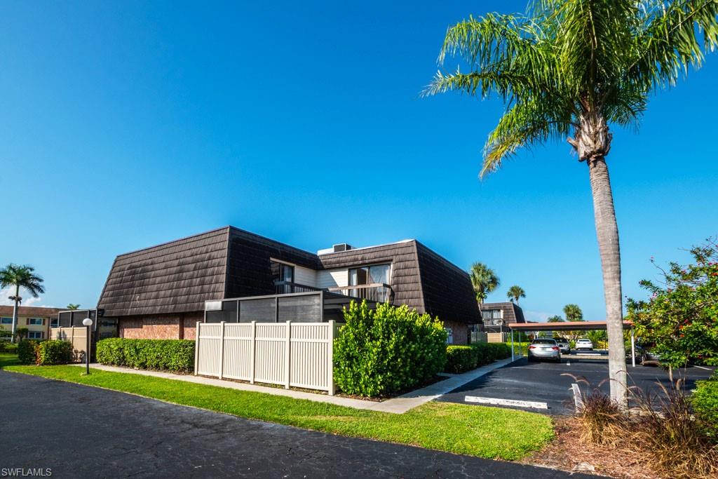 124 Lake Point Lane, Unit 2B Naples, FL 34112 - Photo 41 of 41 a view of a house with a yard and potted plants
