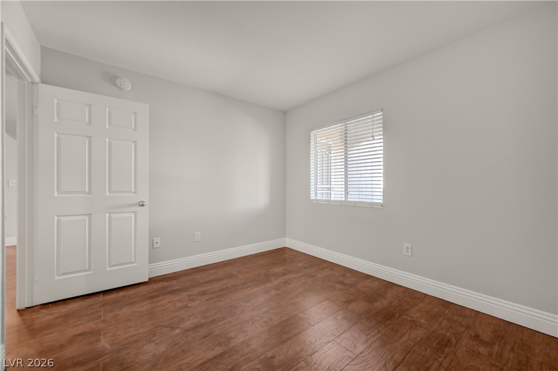 7885 West Flamingo Road, Unit 1050 Las Vegas, NV 89147 - Photo 30 of 62 A well-lit room with warm wood flooring offers a comfortable living space.