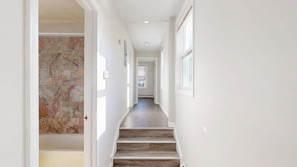 329 Paris Street, Unit 2 Boston, MA 02128 - Photo 11 of 24 a view of a hallway with wooden floor and entryway