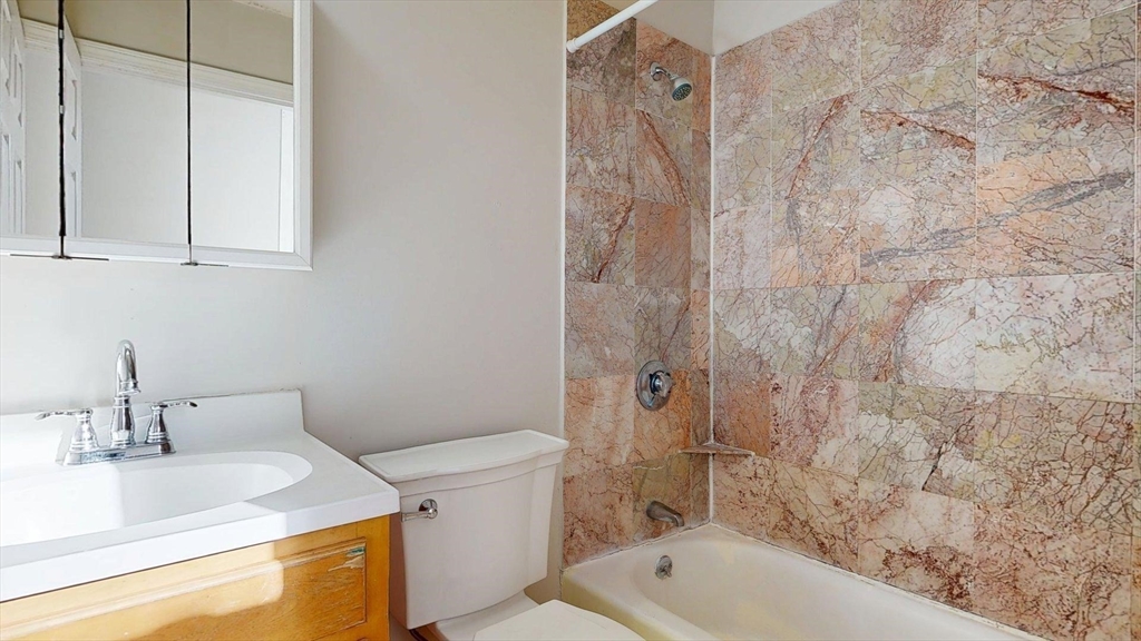 329 Paris Street, Unit 2 Boston, MA 02128 - Photo 12 of 24 a bathroom with a sink and a toilet