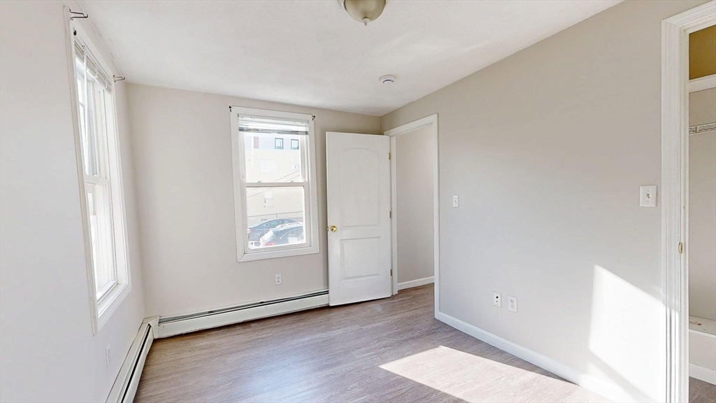329 Paris Street, Unit 2 Boston, MA 02128 - Photo 15 of 24 an empty room with window