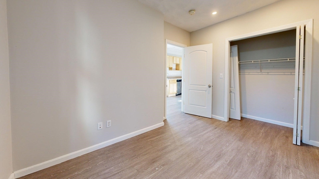 329 Paris Street, Unit 2 Boston, MA 02128 - Photo 18 of 24 a view of wooden floor and windows in a room
