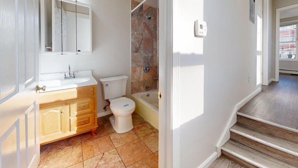 329 Paris Street, Unit 2 Boston, MA 02128 - Photo 4 of 24 a bathroom with a sink toilet and shower