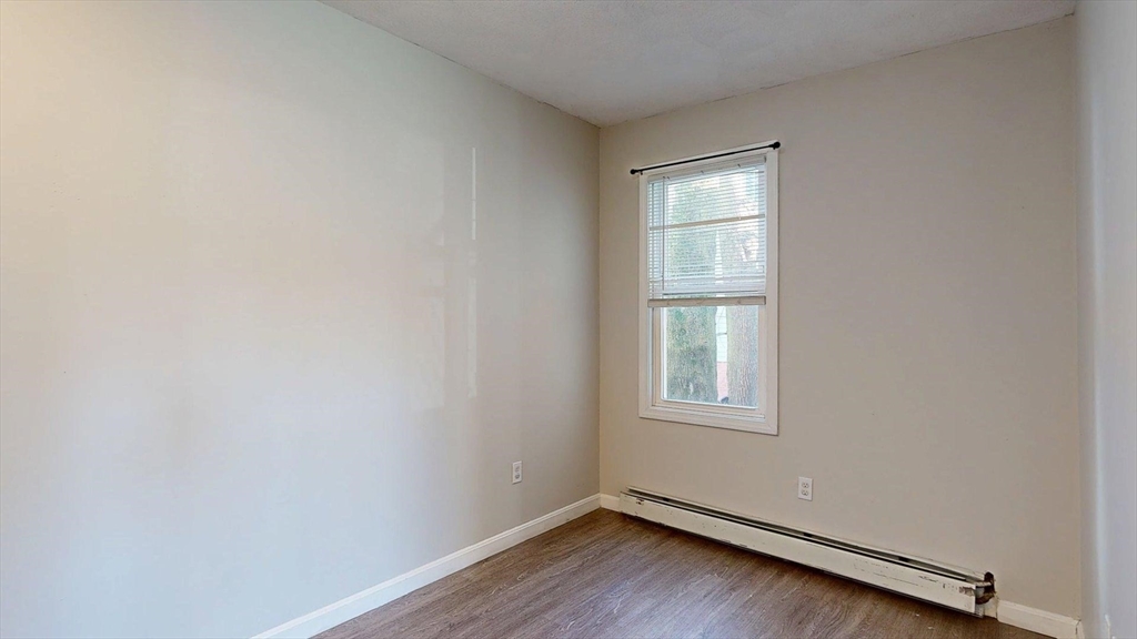 329 Paris Street, Unit 2 Boston, MA 02128 - Photo 8 of 24 an empty room with a window