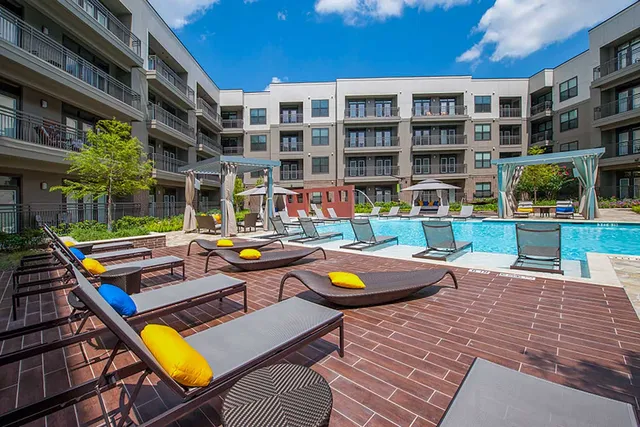 a swimming pool with outdoor seating and yard