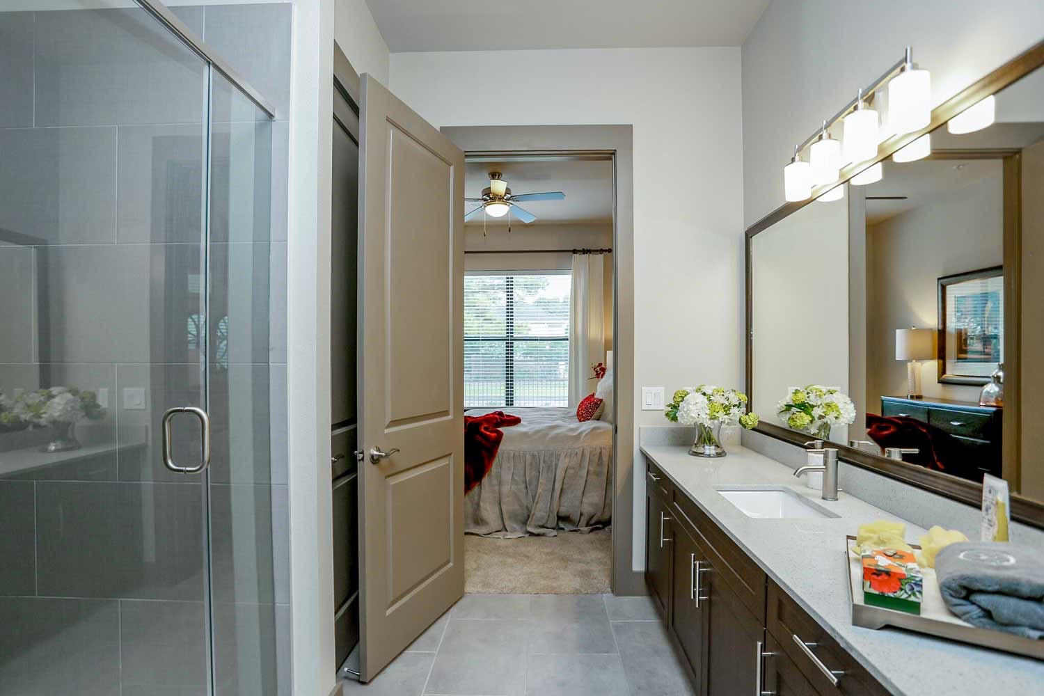 2033 South Gessner Road, Unit 4312 Houston, TX 77063 - Photo 23 of 25 a en suite bathroom with a double vanity sink a large mirror and a shower