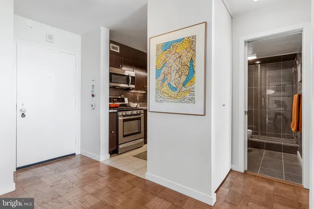 a kitchen with stainless steel appliances a refrigerator and a stove top oven