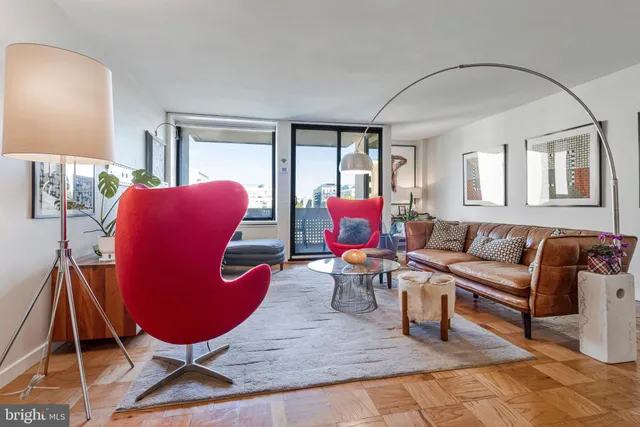 a living room with furniture rug and window