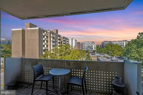a view of a chairs and table in the balcony