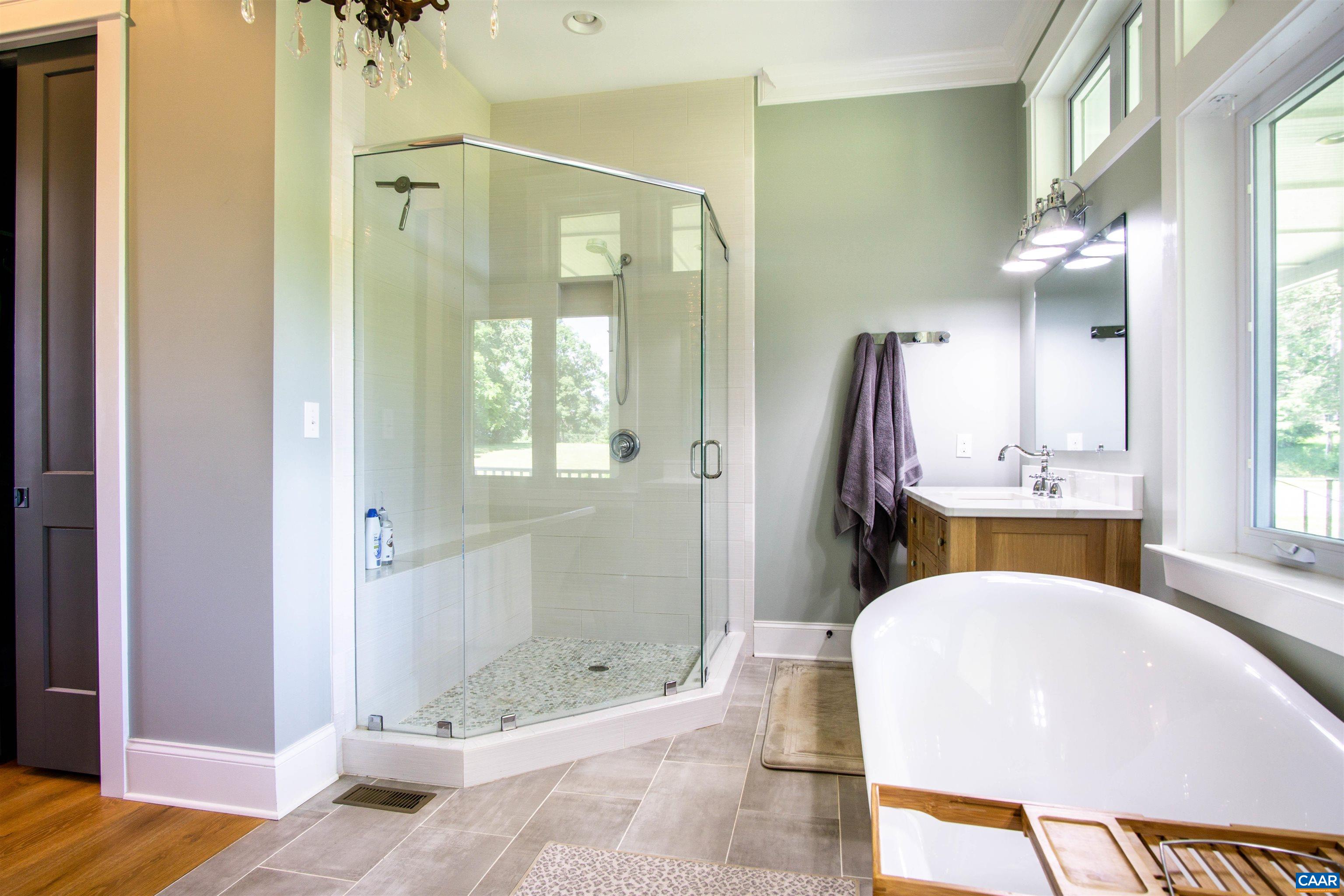 2236 Moore Road Ruckersville, VA 22968 - Photo 26 of 69 a bathroom with a tub shower sink and mirror