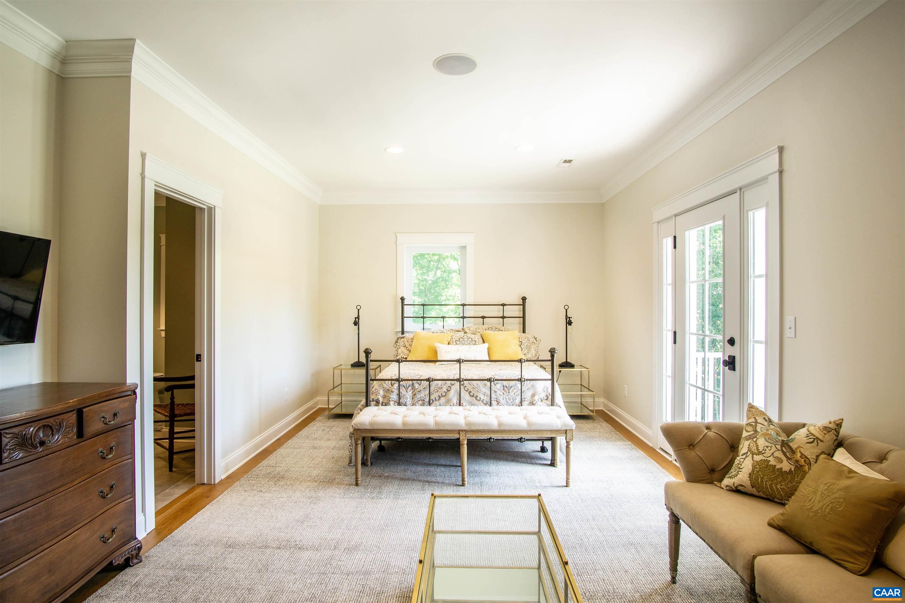 2236 Moore Road Ruckersville, VA 22968 - Photo 40 of 69 a spacious bedroom with a bed and a couch