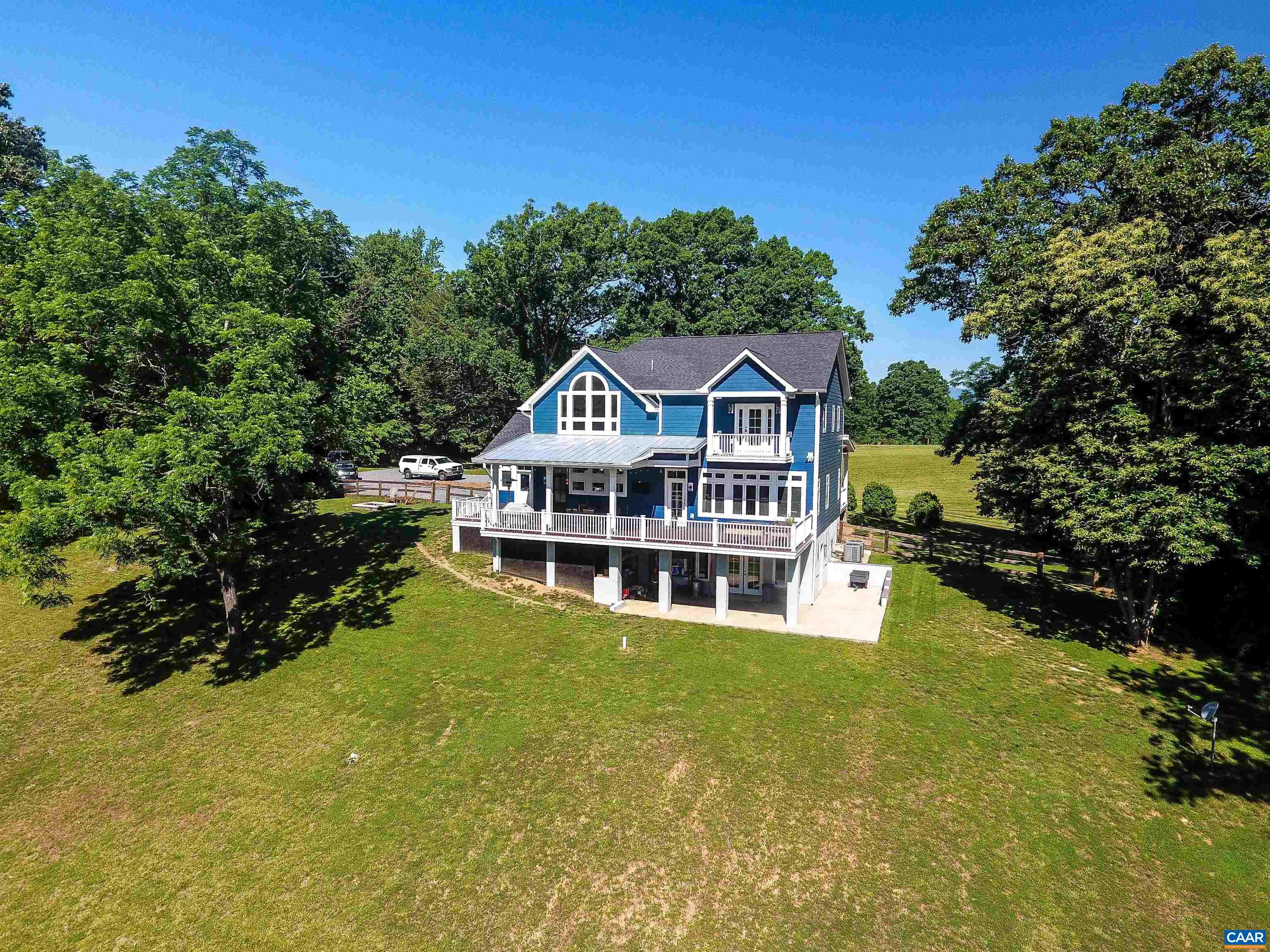 2236 Moore Road Ruckersville, VA 22968 - Photo 4 of 69 a view of a house with a big yard and large trees