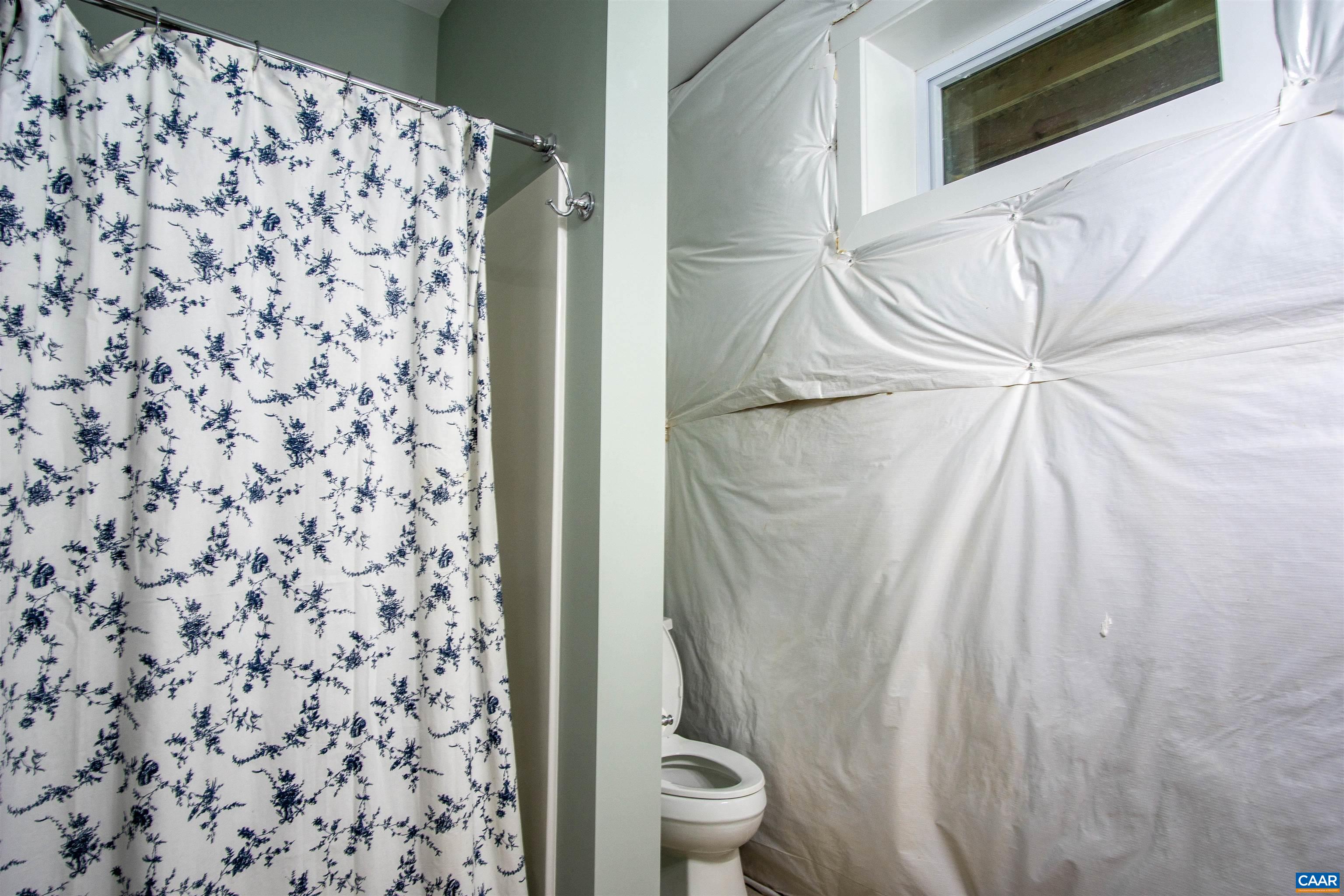2236 Moore Road Ruckersville, VA 22968 - Photo 51 of 69 a bathroom with a shower curtain