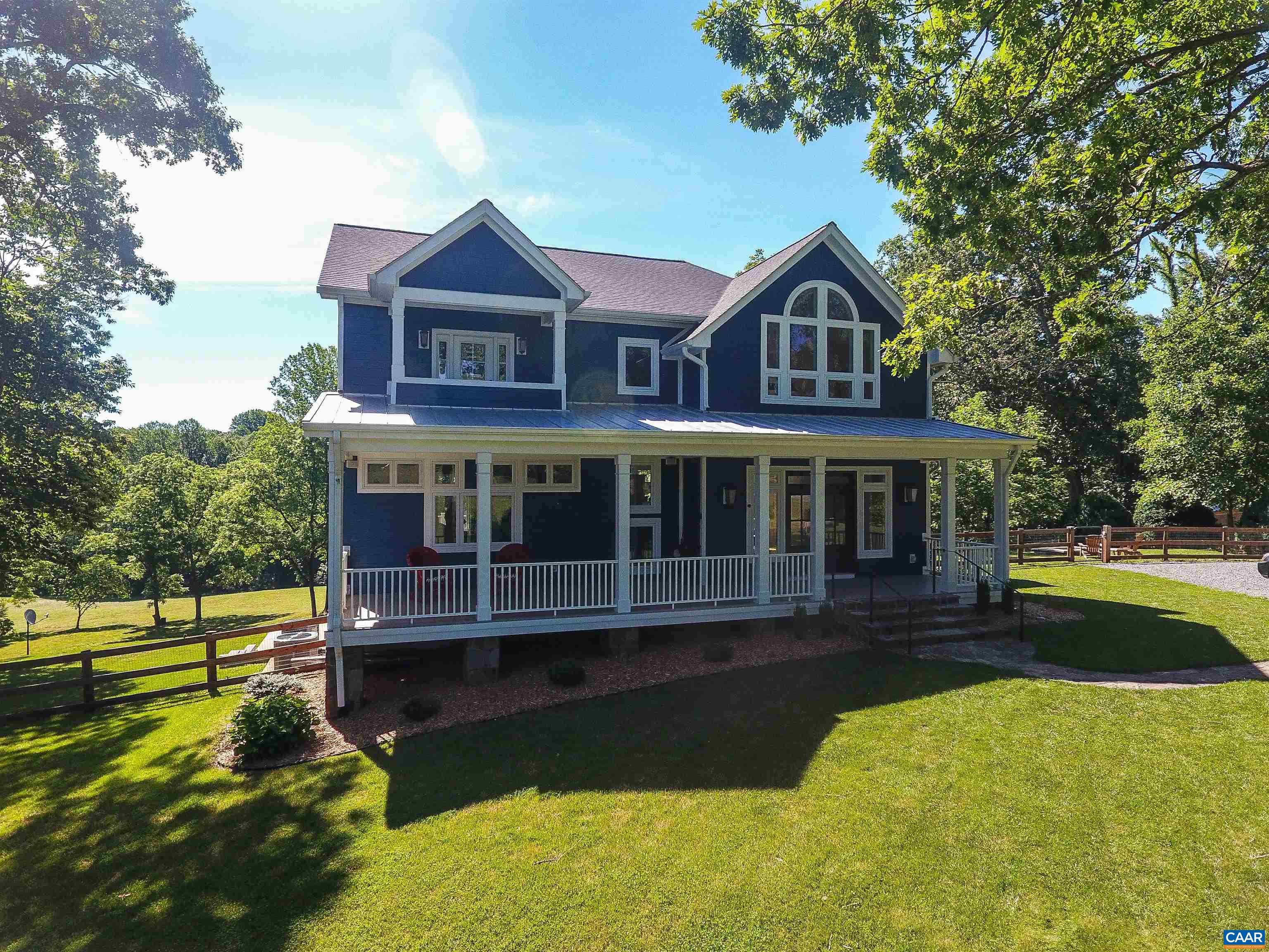 2236 Moore Road Ruckersville, VA 22968 - Photo 56 of 69 a front view of a house with a yard table and chairs