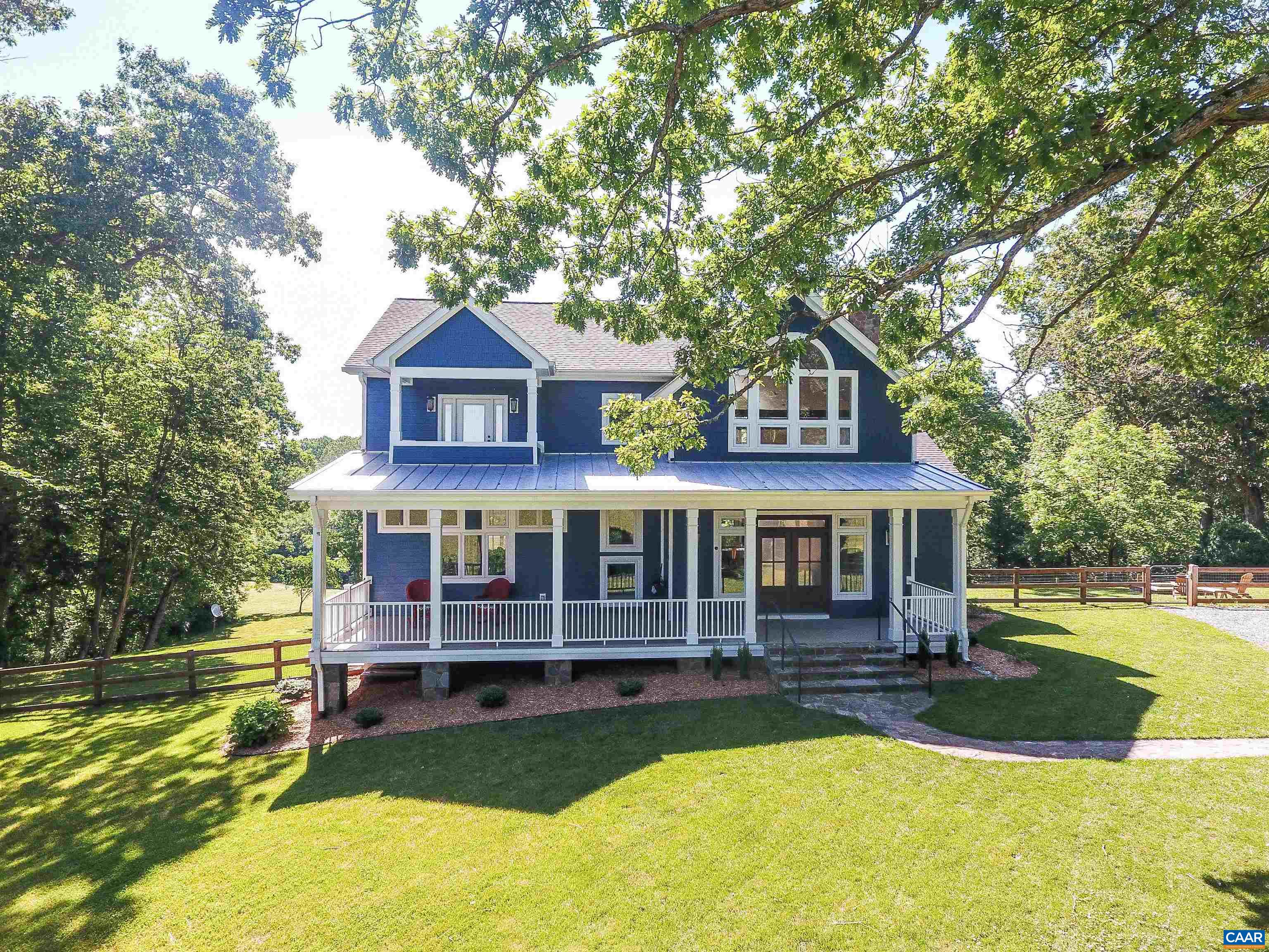 2236 Moore Road Ruckersville, VA 22968 - Photo 6 of 69 a front view of a house with a yard table and chairs
