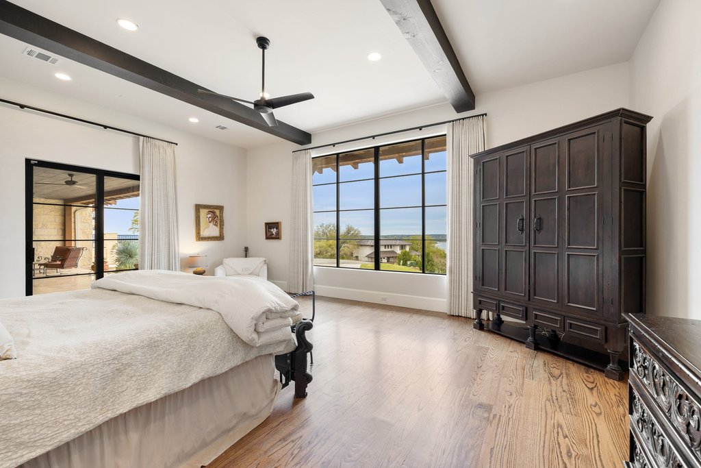 4001 Tejon Circle Austin, TX 78734 - Photo 24 of 40 a spacious bedroom with a large bed and a large window