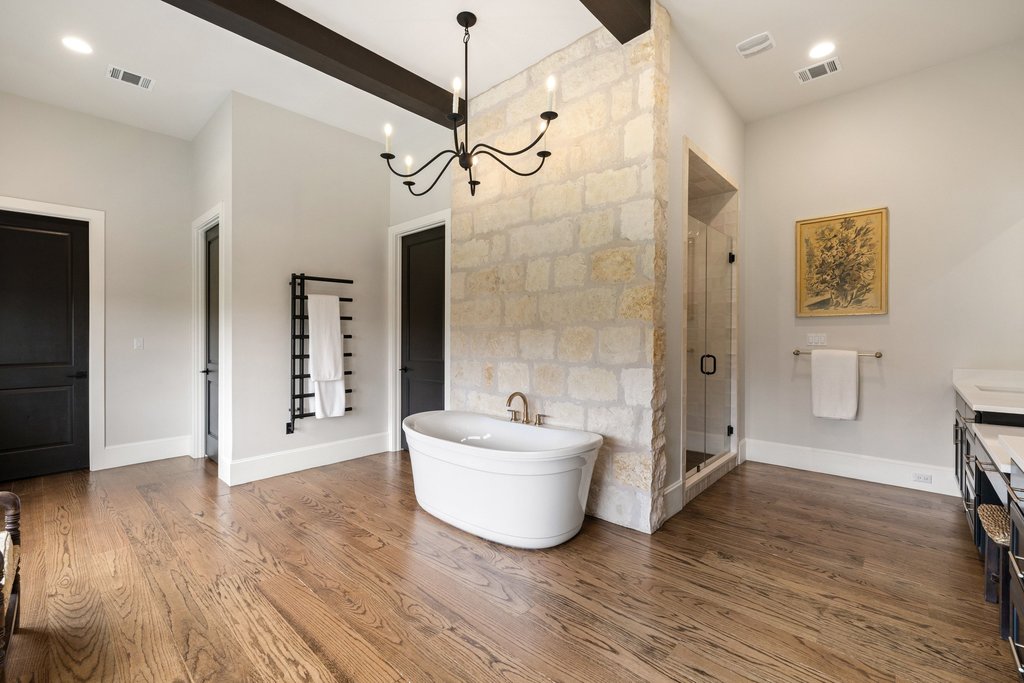 4001 Tejon Circle Austin, TX 78734 - Photo 26 of 40 a spacious bathroom with a double vanity sink a mirror and a bathtub
