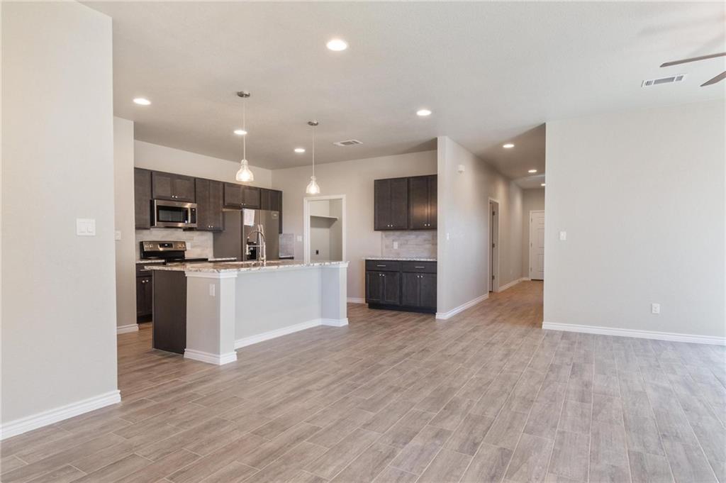 365 County Road 306, Unit A Jarrell, TX 76537 - Photo 9 of 9 a view of kitchen with granite countertop cabinets and refrigerator
