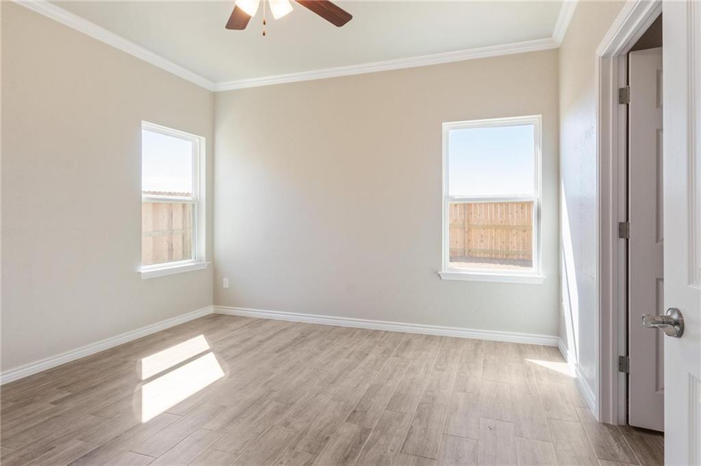 365 County Road 306, Unit A Jarrell, TX 76537 - Photo 4 of 9 a view of empty room with wooden floor and fan