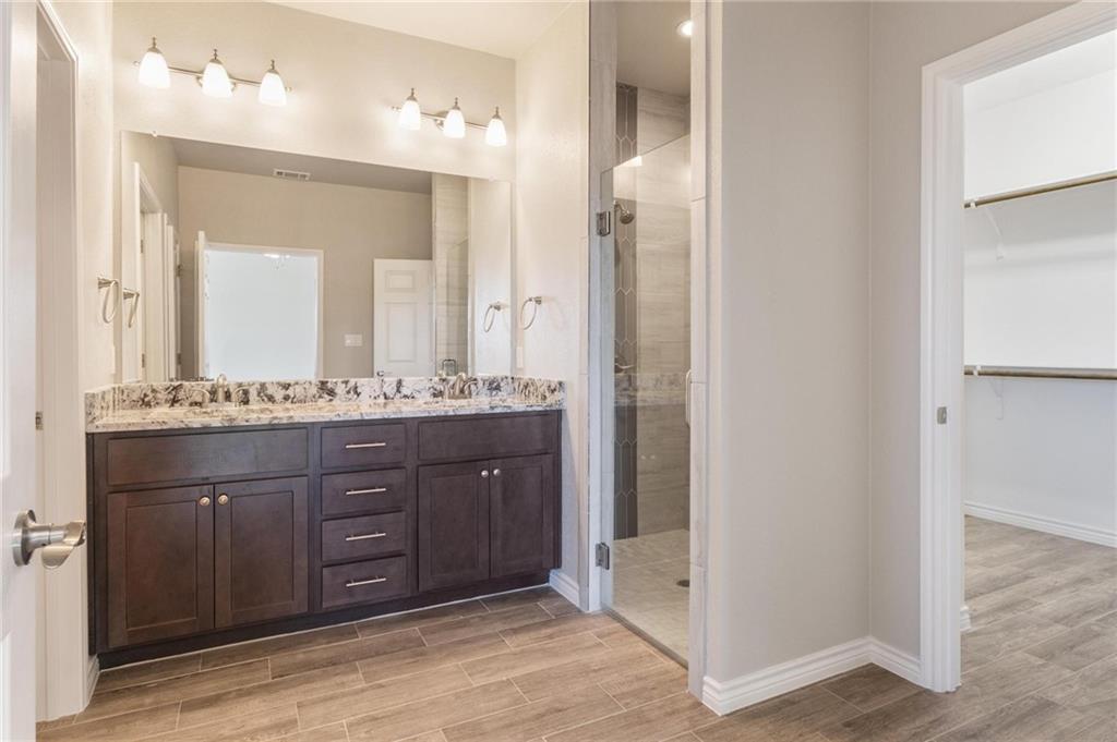 365 County Road 306, Unit A Jarrell, TX 76537 - Photo 6 of 9 a bathroom with a granite countertop sink and a mirror