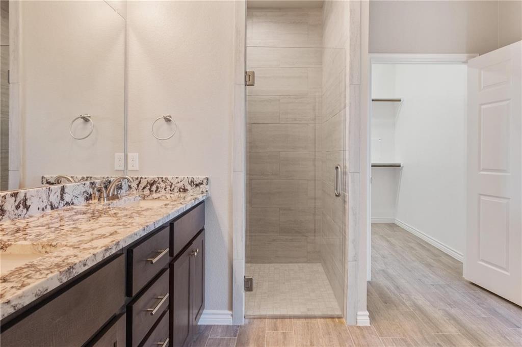 365 County Road 306, Unit A Jarrell, TX 76537 - Photo 7 of 9 a bathroom with a granite countertop sink and a mirror