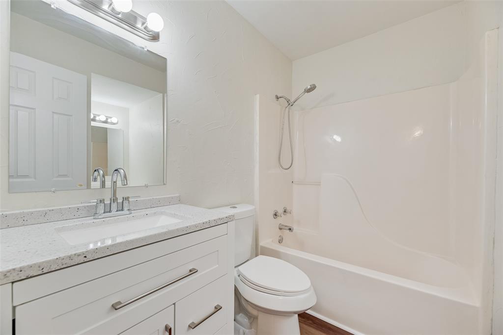751 County Road 1240 Mount Pleasant, TX 75455 - Photo 28 of 35 a bathroom with a sink a toilet and a bathtub