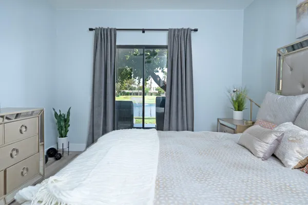 a bedroom with a bed and a window